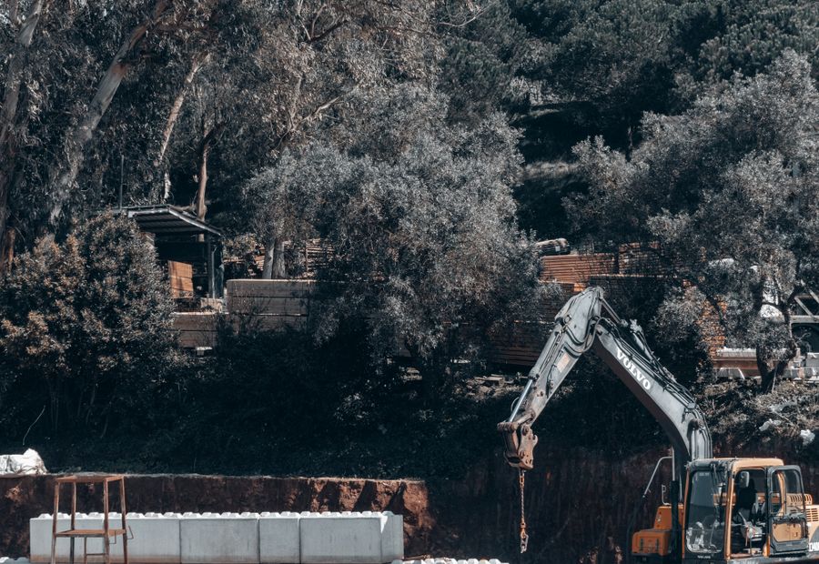 Excavator working a large cut on a commercial septic installation